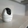 An indoor home security camera sitting on a kitchen counter